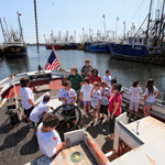 Campers explore the harbor aboard the Schooner Ernestina