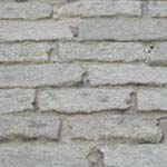 Close-up view of Belgian block pavers, which are rectangular, grayish and packed in with sand to pave streets in the historic district.