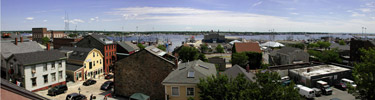 A panoramic view of historic buildings, cobblestone streets, and New Bedford's waterfront
