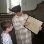 A boy examines a map of family pews.
