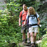 Two backpackers make their way down a rocky trail in Shenandoah National Park.