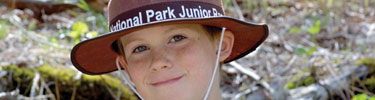 A boy proudly wears his Junior Ranger hat!
