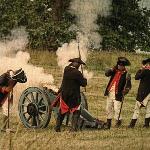 Soldiers firing a cannon