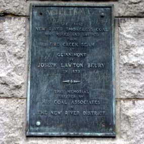 A weathered metal plaque dedicated to Joseph Lawton Beury