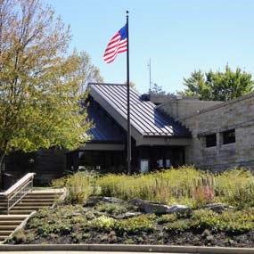An American flag flying at the front entrance to the Canyon Rim Visitor Center.