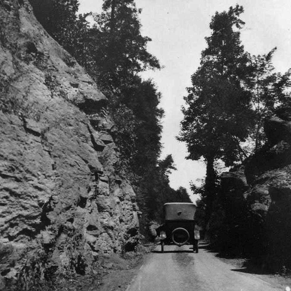 early model automobile traveling down the very narrow Fayete Station Road