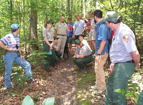 NPS staff and volunteers discussing trail design with IMBA representatives