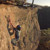rock climber on cliff over gorge