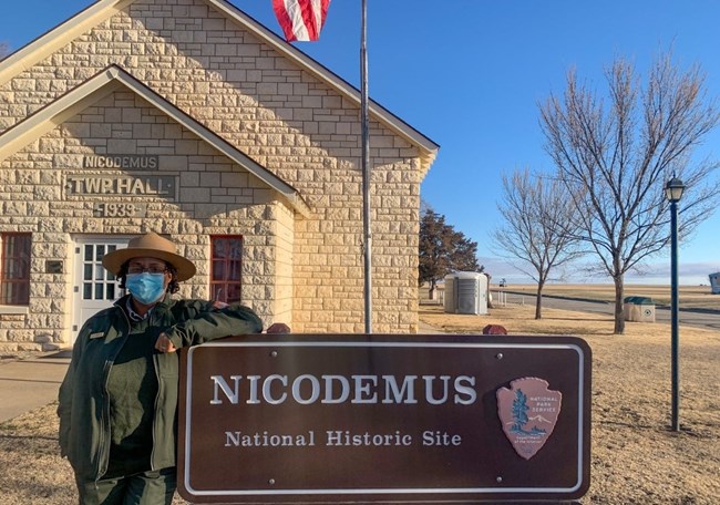 Ranger standing next to sign