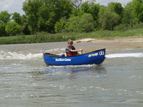 A canoer slips over a Class II- Ledge at Fritz's Island