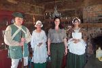 Park staff and costumed interpreters in cabin