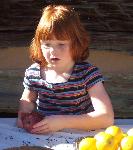 Little red headed girl making colonial pomander
