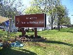 Park sign with tents