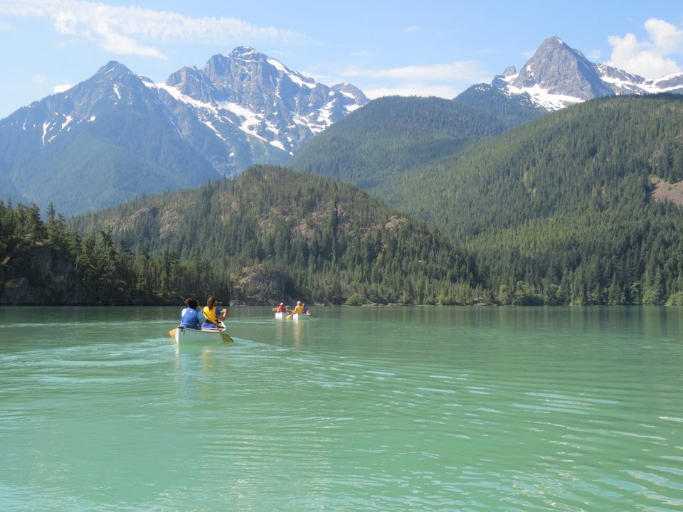 Canoers on turquoise waters of lake