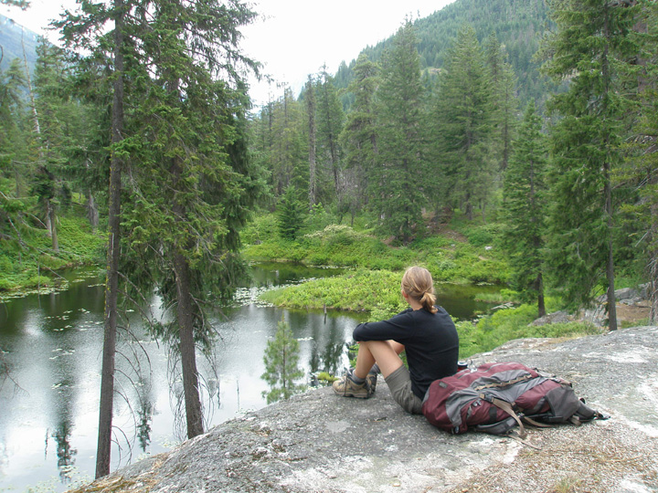 Hiker on rocks overlooking Coon Lake