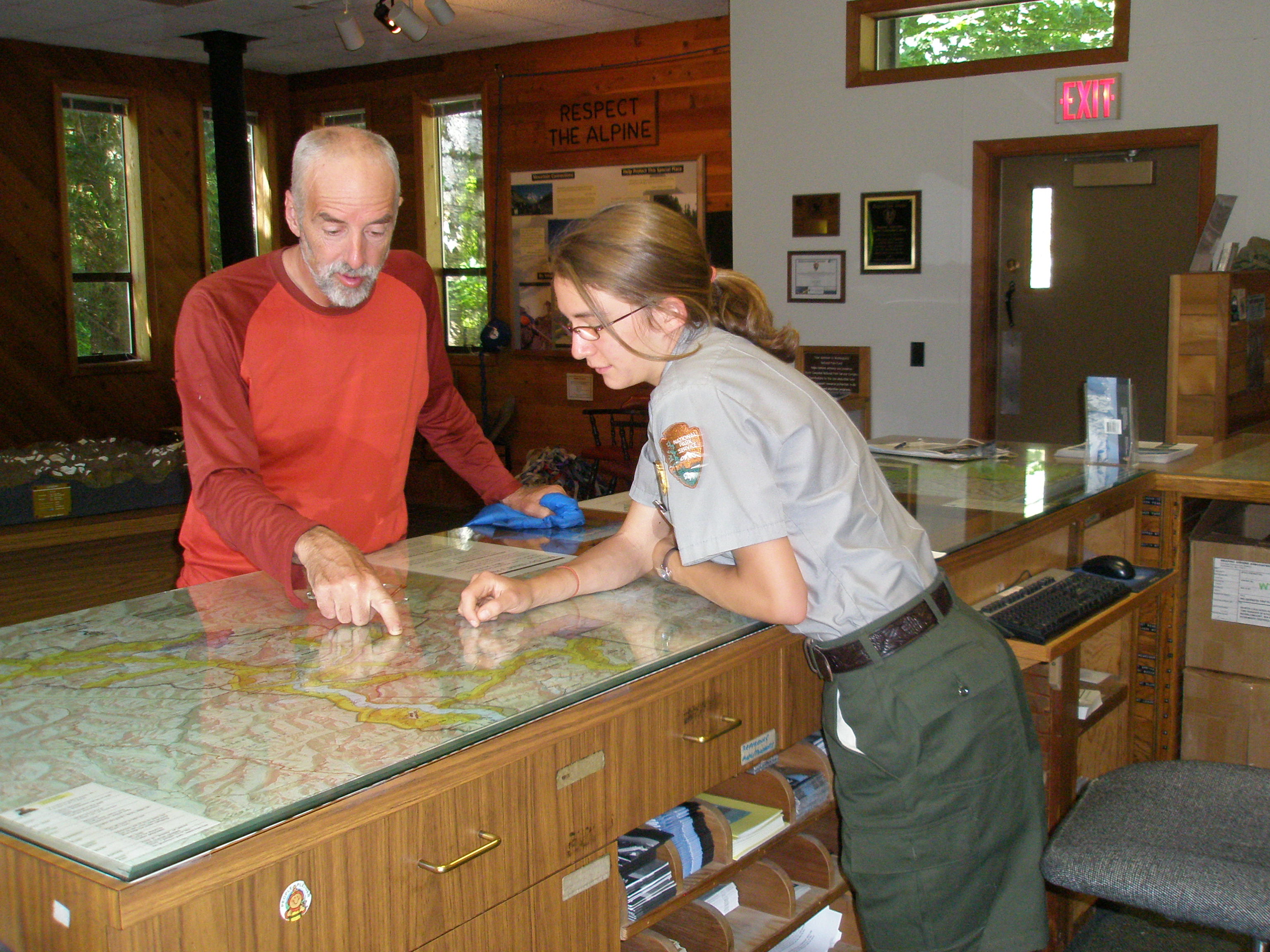 Visitor and ranger look at map