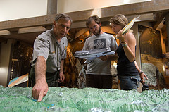 A Backcountry Ranger shows visitors their campsite on a 3D relief of the Park