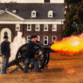 Re-enactors fire a cannon at Governors Island.