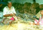 Fitiuta woman weaving fine mat with lau fala