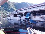 Photo of car suspended from window of Pago Community Center