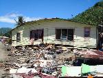 Photo of buckled house.
