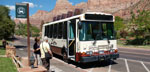 Photo of two people boarding a Zion shuttle bus