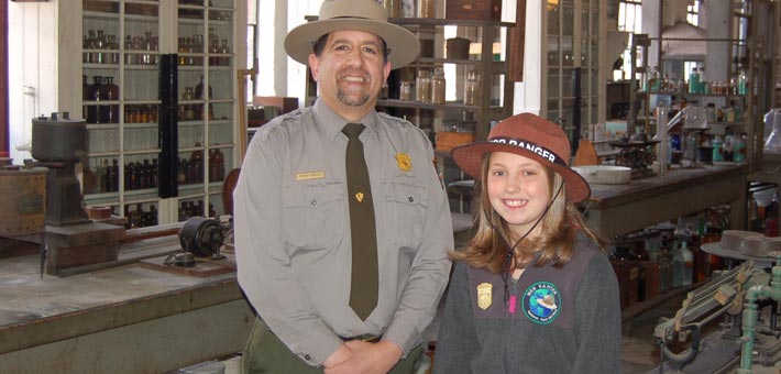 Photo of Rachel Koblitz, the 10,000th WebRanger, with a park ranger at Thomas Edison National Historical Park