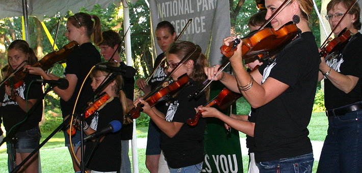 Photo of a group of fiddlers on stage