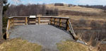 Photo of wayside exhibit overlooking dry lake bed and former dam site