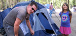 Photo of campers setting up a tent