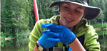 Photo of Mount Rainier’s citizen science coordinator holding a frog