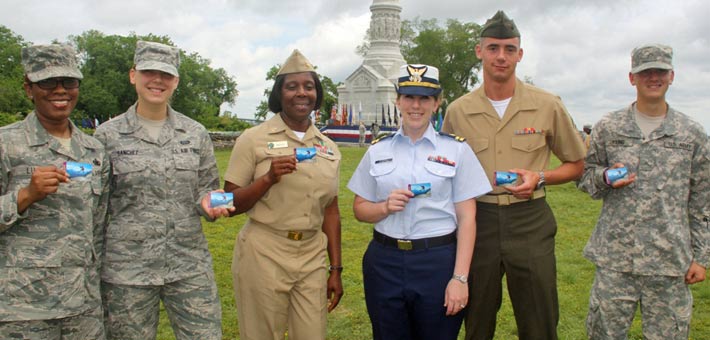 Photo of active duty military showing off their new passes