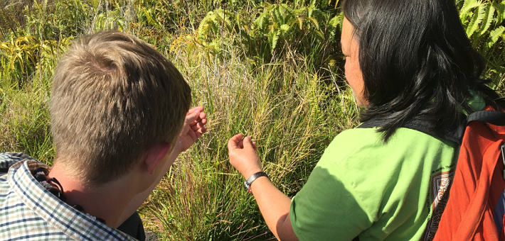 Two students studying grass