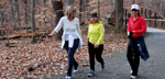 Photo of three women hiking on trail