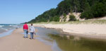 Photo of two people walking along Twelvemile Beach at Lake Superior in the Beaver Basin Wilderness