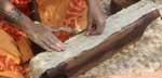 Photo of a woman beating tapa cloth during the cultural festival at Pu’ukohola Heiau National Historic Site