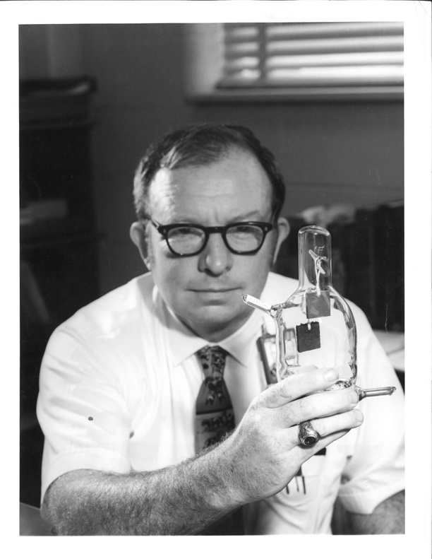 Chemist Bill Harper holding a flask