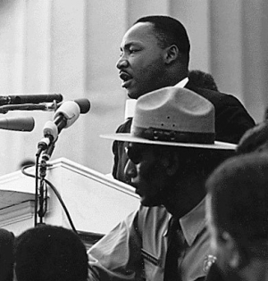 Martin Luther King Jr giving speech with Park Ranger in photo