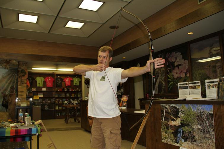 Travis demonstrating with a bow