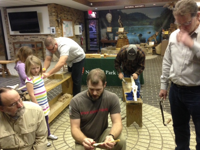 Visitors learning about how to construct the primitive bow