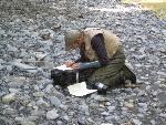 Fish biologist records observations.