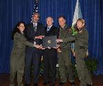five people holding an award
