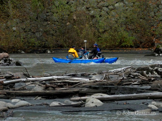 Members of the sediment float down the Elwha River in rafts outfitted with equipment to study sediment redistribution.