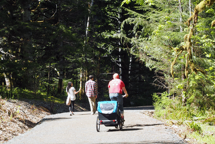 people walking and biking on Spruce Railroad Trail