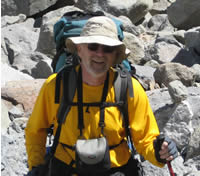 man wearing yellow shirt and tan hat man wearing yellow shirt and tan hat