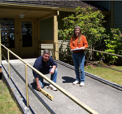 man and woman on entry ramp to building