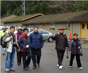 group of people walking through parking lot