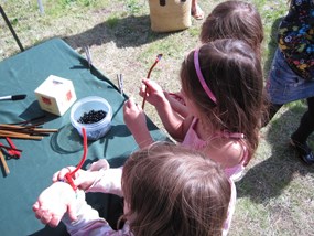 Children create their rock cycle bracelets during Rogue Valley Earth Day.