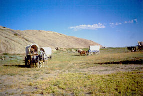 Photo image of Independence Rock and emigrant wagons.