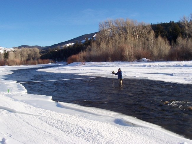 NPS scientist measures flow of river.